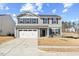 Charming two-story home featuring a classic gray facade, attached two-car garage, and well-maintained front lawn at 1004 Bridgewater Dr, Durham, NC 27704