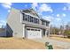 Charming two-story home with a gray exterior, black shutters, and a two-car garage at 1004 Bridgewater Dr, Durham, NC 27704