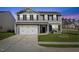 Charming two-story home featuring a classic gray facade, attached two-car garage, and well-maintained front lawn at 1004 Bridgewater Dr, Durham, NC 27704