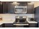 Kitchen with stainless steel appliances and dark cabinets at 1004 Bridgewater Dr, Durham, NC 27704