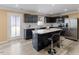 Modern kitchen features an island with bar seating, stainless steel appliances, and ample counter space at 1004 Bridgewater Dr, Durham, NC 27704