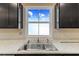 Kitchen sink with window and black cabinets at 1004 Bridgewater Dr, Durham, NC 27704