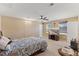 Large carpeted bedroom with ceiling fan features two windows, a bed, and a flat screen tv in the corner at 1004 Bridgewater Dr, Durham, NC 27704