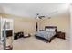 Spacious bedroom with ceiling fan, carpet, and a connected bathroom and walk-in closet at 1004 Bridgewater Dr, Durham, NC 27704