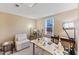 A spacious home office features natural light, a large desk, and a comfortable chair, perfect for remote work or study at 1004 Bridgewater Dr, Durham, NC 27704