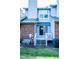 Rear exterior view of home, featuring a brick section, patio door, and an AC unit at 1004 Hempstede Dr, Zebulon, NC 27597
