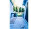 View of back porch made of painted wood with stairs leading into the yard and trees at 1004 Hempstede Dr, Zebulon, NC 27597