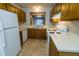 Classic kitchen with wood cabinets and white appliances at 1004 Hempstede Dr, Zebulon, NC 27597