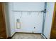 Functional laundry room with storage shelf, tiled floor, and hookups for appliances at 1004 Hempstede Dr, Zebulon, NC 27597