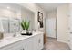 Bathroom features double sinks, white cabinets, a large mirror, and tiled floors at 1008 Octans Way, Wendell, NC 27591