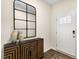 Charming entryway with decorative mirror, stylish cabinet, and bright front door at 1008 Octans Way, Wendell, NC 27591