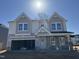 Charming two-story home boasts stone accents, a two-car garage, and inviting curb appeal at 1041 Bostonian Dr, Knightdale, NC 27545