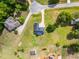 Aerial shot of brick home with gray roof and curved driveway in a neighborhood with large green lawns at 105 Pinecrest Dr, Angier, NC 27501