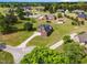 Aerial view of brick home with black roof, mature trees, and a long driveway in a quiet neighborhood at 105 Pinecrest Dr, Angier, NC 27501