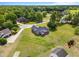 Aerial view of a brick home with dark roof surrounded by lush green lawns and mature trees in the neighborhood at 105 Pinecrest Dr, Angier, NC 27501