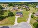 Aerial view of a home surrounded by green lawns and mature trees in a large residential neighborhood at 105 Pinecrest Dr, Angier, NC 27501
