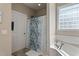 Bright bathroom with a soaking tub, shower, and decorative shower curtain at 105 Pinecrest Dr, Angier, NC 27501