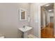 Bathroom with a pedestal sink and access to hallway at 105 Pinecrest Dr, Angier, NC 27501