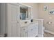 Bright bathroom features a vanity with storage, a large mirror, and neutral wall colors at 105 Pinecrest Dr, Angier, NC 27501