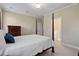 Primary bedroom with a four-poster bed, a dresser, and an ensuite bathroom at 105 Pinecrest Dr, Angier, NC 27501