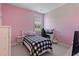 This bedroom features pink walls, carpet, a window, and a desk at 105 Pinecrest Dr, Angier, NC 27501