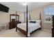 Primary bedroom with a four poster bed, dressers, carpet, and plenty of natural light at 105 Pinecrest Dr, Angier, NC 27501