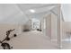 Large bonus room with neutral carpet, exercise equipment, and natural light at 105 Pinecrest Dr, Angier, NC 27501