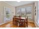 Sun-filled dining area with hardwood floors, white walls, and wooden dining table set at 105 Pinecrest Dr, Angier, NC 27501