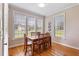 Sunlit dining area with hardwood floors, large windows, and wooden table and chairs at 105 Pinecrest Dr, Angier, NC 27501