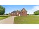 Charming all-brick home featuring an attached garage and a well-manicured front lawn at 105 Pinecrest Dr, Angier, NC 27501