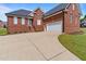Close-up of the brick house with attached garage and long driveway at 105 Pinecrest Dr, Angier, NC 27501