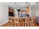 Kitchen with wood cabinets, granite countertops, black appliances, and bar seating at 105 Pinecrest Dr, Angier, NC 27501