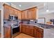 Charming kitchen with granite countertops, stainless steel appliances, and wooden cabinets at 105 Pinecrest Dr, Angier, NC 27501