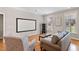 Bright living room featuring hardwood floors, a plush sofa, and an entertainment system at 105 Pinecrest Dr, Angier, NC 27501
