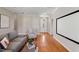 Cozy living room with hardwood floors, neutral paint and decor, and a projection screen at 105 Pinecrest Dr, Angier, NC 27501