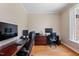 Spacious home office with wood floors, neutral paint, and a window overlooking the exterior at 105 Pinecrest Dr, Angier, NC 27501
