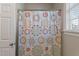 Shower with modern colorful flower curtain and natural light from the window at 105 Pinecrest Dr, Angier, NC 27501