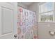Full tub and shower featuring modern curtain and a bright window at 105 Pinecrest Dr, Angier, NC 27501