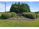 Community entrance sign for Mill Branch with green landscaping and mature shrubs in a well-kept neighborhood at 105 Pinecrest Dr, Angier, NC 27501