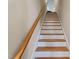 Staircase with hardwood treads, white risers, and a wooden handrail at 105 Pinecrest Dr, Angier, NC 27501