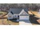 An aerial view of a charming home with a stone facade and an attached two car garage at 110 Lilac Dr, Franklinton, NC 27525