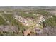Expansive aerial view of a neighborhood with tree-lined streets and well-maintained homes nestled among lush greenery at 110 Lilac Dr, Franklinton, NC 27525