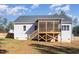 An eye-level shot of a back porch attached to a home with a wooden fence and some green grass at 110 Lilac Dr, Franklinton, NC 27525