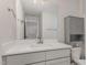 Well-lit bathroom featuring a vanity with a large mirror and a gray storage cabinet at 110 Lilac Dr, Franklinton, NC 27525