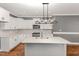 Kitchen showcasing white cabinetry, stainless steel appliances, and a center island with a sink at 110 Lilac Dr, Franklinton, NC 27525