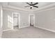 Spacious primary bedroom featuring a tray ceiling, neutral walls, carpet, and ensuite access at 110 Lilac Dr, Franklinton, NC 27525