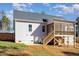 Rear exterior view showcasing the home's siding, screened porch, and backyard access at 110 Lilac Dr, Franklinton, NC 27525