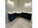 Bright bathroom with double vanities, granite countertops, and wood-look tile floor at 1113 Hudson Dr, Mebane, NC 27302