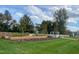 Well-manicured community garden with raised beds, lush green grass, and a gazebo at 1113 Hudson Dr, Mebane, NC 27302