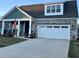 Charming home exterior boasts stone accents, a two-car garage, and a manicured lawn at 1113 Hudson Dr, Mebane, NC 27302